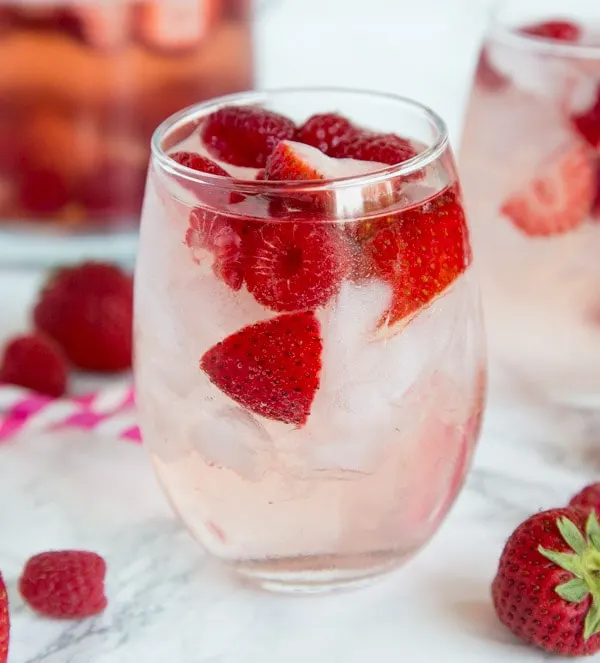 Berry Rosé Sangria - Use Rose wine to make this refreshing and easy sangria for summer. Loaded with raspberry and strawberries for a great summer cocktail.