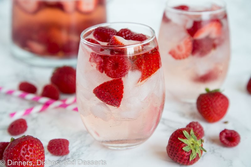 A close up berry rose sangria in a glass