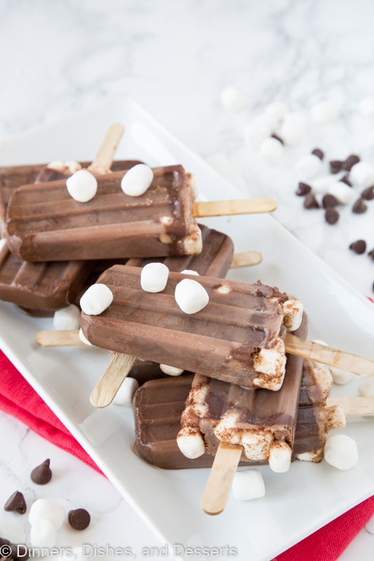 Plate of hot chocolate popsicles with marshmallows
