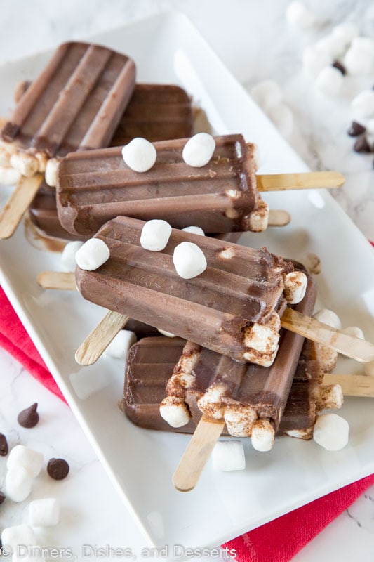 Hot Chocolate popsicles on a plate with marshmallows
