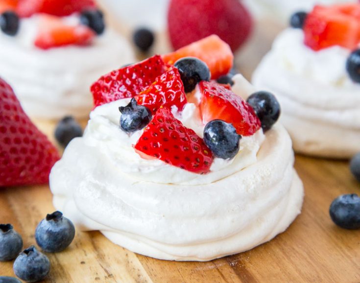 Mini Pavlova Recipe - crispy meringue made into single servings!  Topped with fresh whipped cream and berries for a light and delicious dessert any time.  