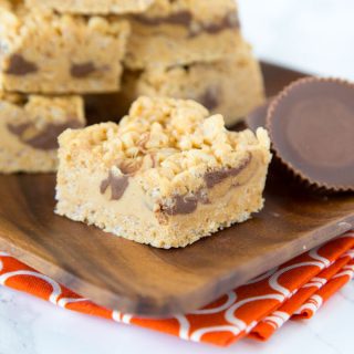 Peanut Butter Rice Krispie Treats - Classic rice krispie treats turned up a notch with lots of peanut butter, peanut butter fudge, and peanut butter cups!  No bake, super easy, and over the top amazing! 