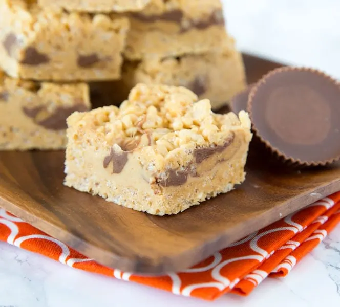 Peanut Butter Rice Krispie Treats - Classic rice krispie treats turned up a notch with lots of peanut butter, peanut butter fudge, and peanut butter cups!  No bake, super easy, and over the top amazing! 