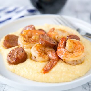 Shrimp and Grits Recipe - this easy shrimp and grits is ready in minutes and is perfect for busy weeknights.  Cheesy grits take it over the top, the whole family is going to love it!  