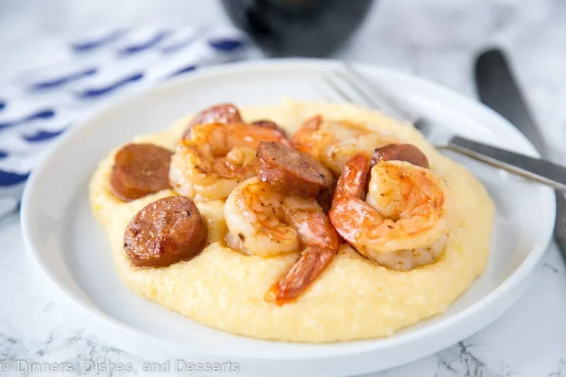 A plate of food, with Grits and Shrimp and grits