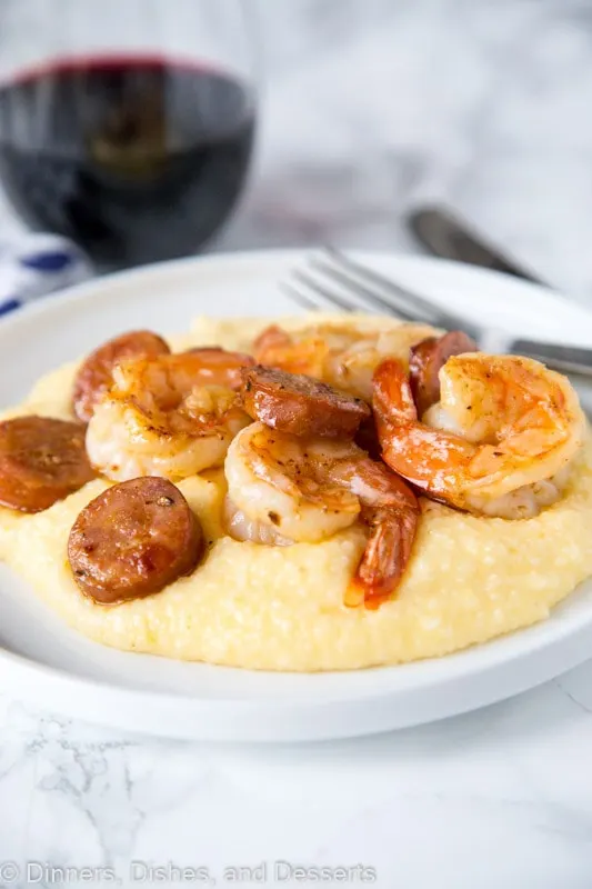 A plate of food on a table, with Grits and Shrimp and grits