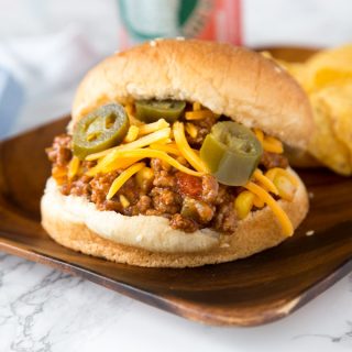 Taco Sloppy Joes - homemade sloppy Joes just got a Mexican makeover! Seasoned with taco seasoning, chilies and topped with cheese make them perfect for any night of the week!