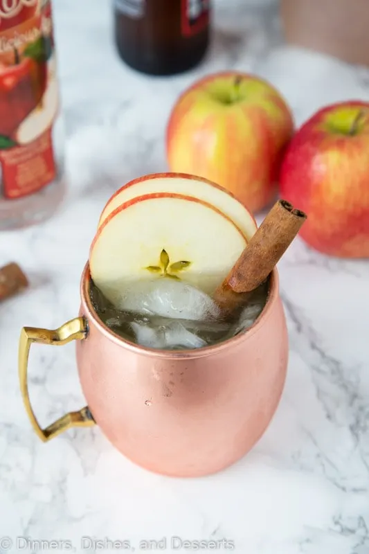 Apple cider flavored moscow mule in a glass with apple slices