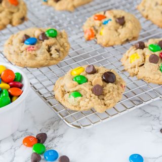 Soft Monster Cookies - a soft and chewy cookie that is a cross between a peanut butter cookie, an oatmeal cookie, and a chocolate chip cookie!  Full of lots of goodies everyone loves them!