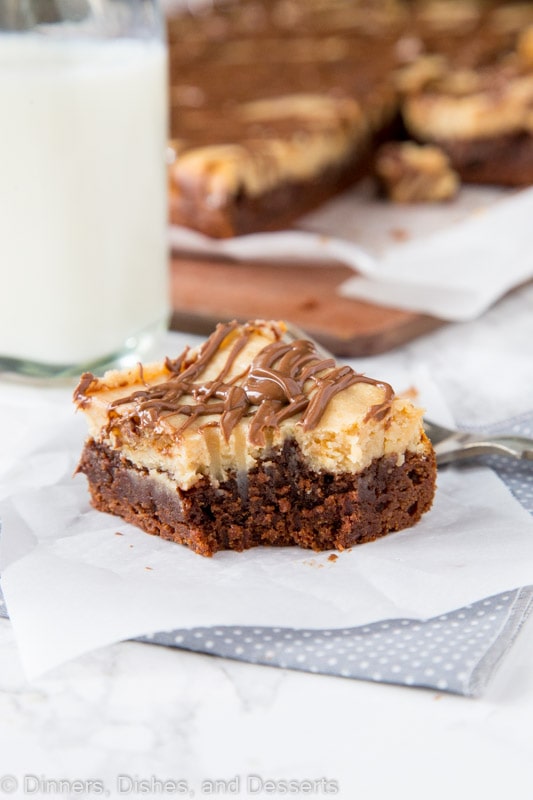 Peanut butter cheesecake brownie on a table with bit missing