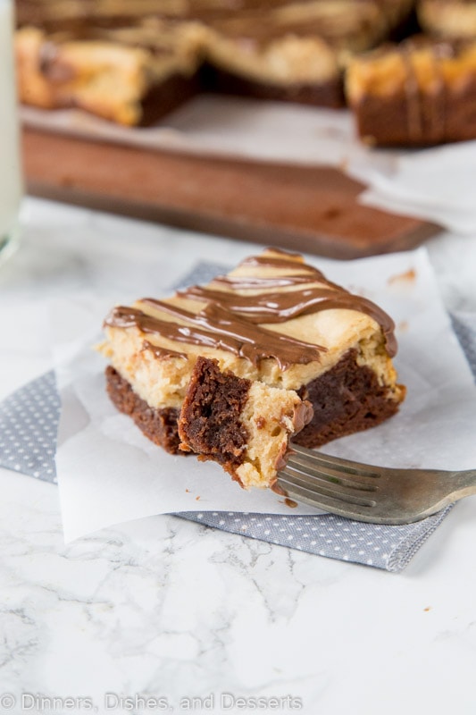 Peanut butter cheesecake brownie on a table with a bite on the fork