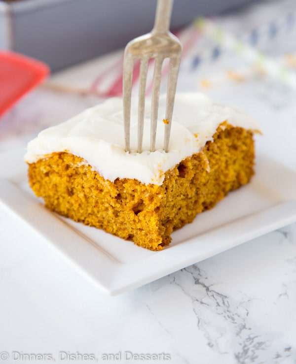 A piece of pumpkin cake on a plate, with a fork