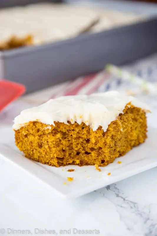 A piece of pumpkin cake sitting on top of a paper plate