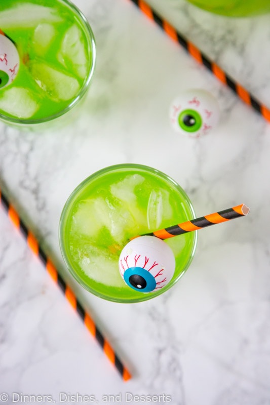 A cup of green Hawaiian punch with plastic eyeball for Halloween
