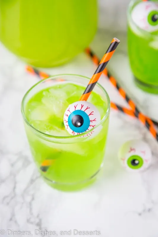 A cup of green Hawaiian punch with plastic eyeball for Halloween