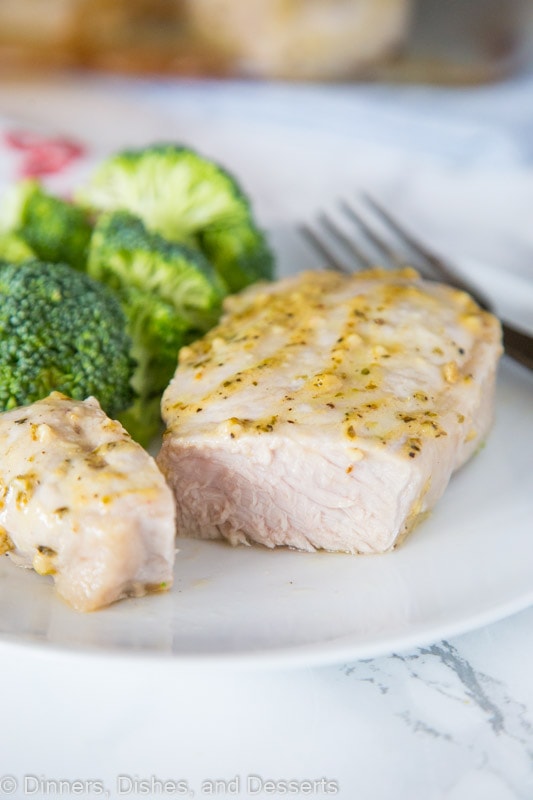 A close up of food on a plate, with Pork and Pork chop