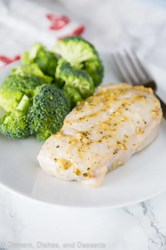 A plate of food with broccoli, with Pork and Pork chop