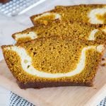 A slice of pumpkin bread with cream cheese swirl