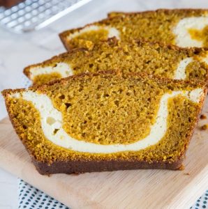 A slice of pumpkin bread with cream cheese swirl