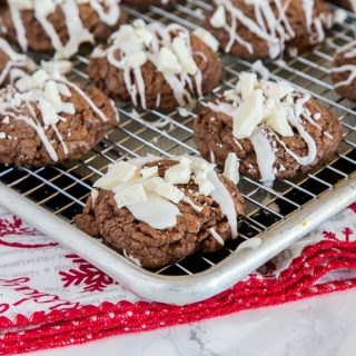 Chocolate Peppermint Cookies - these chocolate cookies have a hint of peppermint and are super fudgy.  They are topped with a white peppermint glaze and more peppermint candies. 