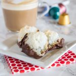 plate of coconut cookies dipped in chocolate
