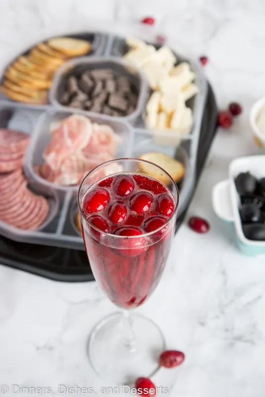 cranberry and wine next to tray of food