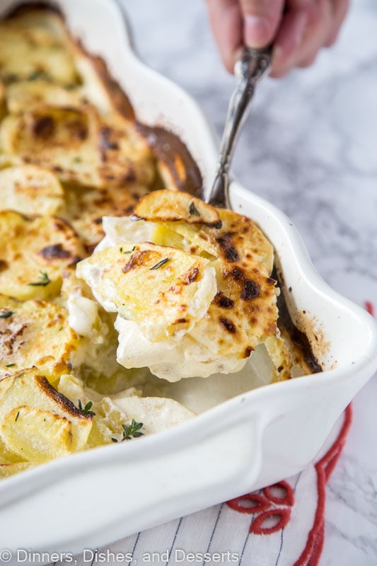 spoonful of potatoes over a casserole dish