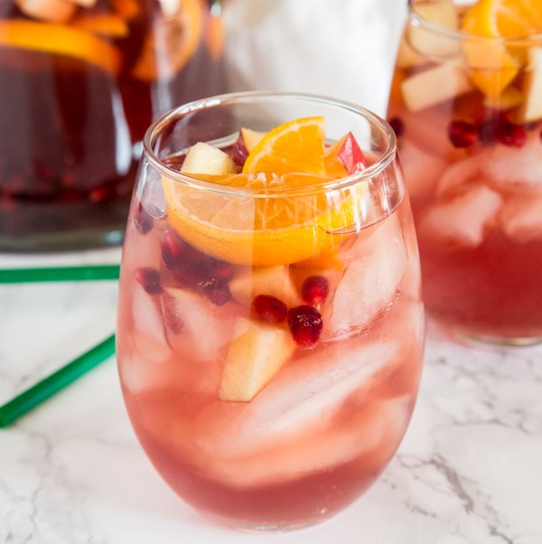 Christmas Sangria Recipe - This fun white wine sangria and all full of fall and winter flavors. It is perfect for Christmas and all your winter get togethers! 