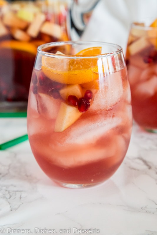 A close up of a glass cup on a table, with Sangria and Wine