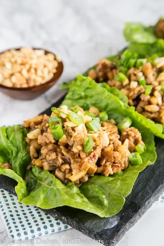A plate of food with lettuce cups filled with chicken