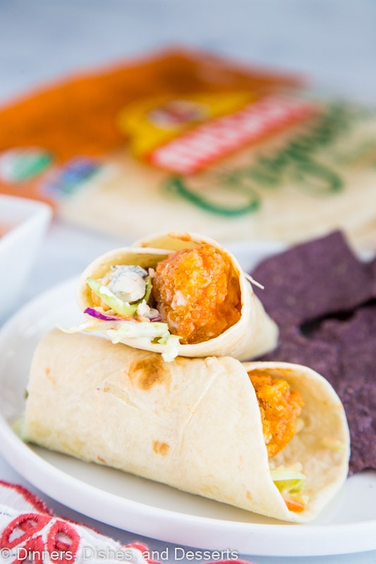 A buffalo chicken wrap on a plate, with Wrap and Dinner