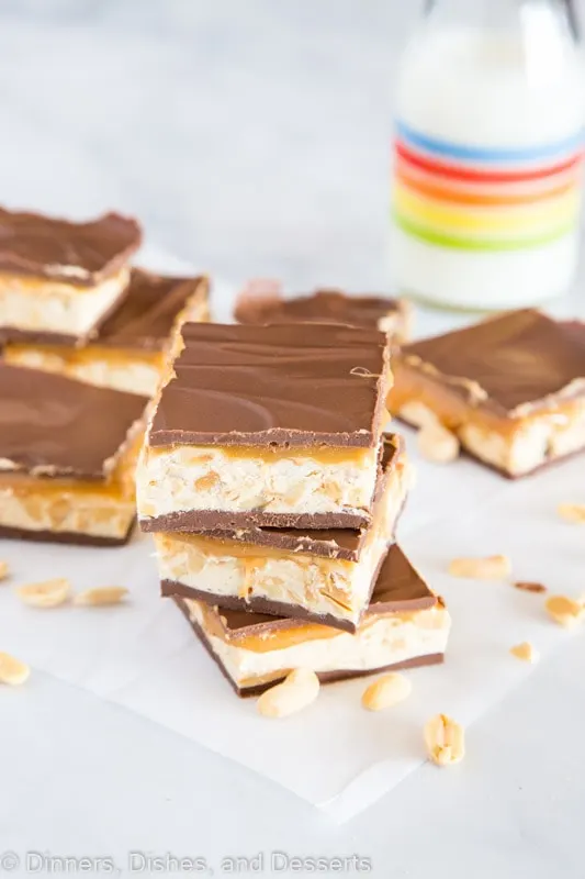 chocolate caramel nougat bars stacked on a table, with Nougat and Peanut