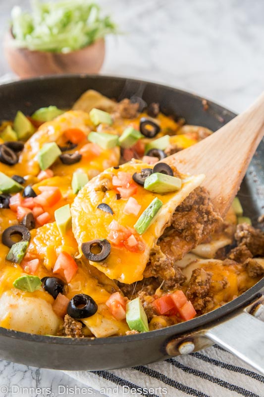 A pan filled with food, with Taco and Pierogi