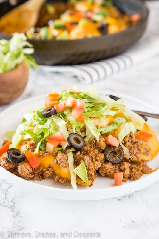 A plate of food on a table, with Taco and Pierogi