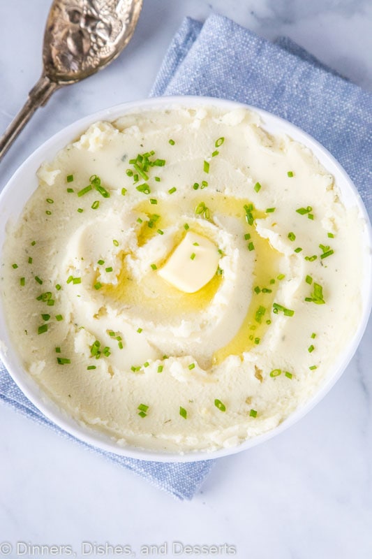 A plate of mashed potatoes with butter
