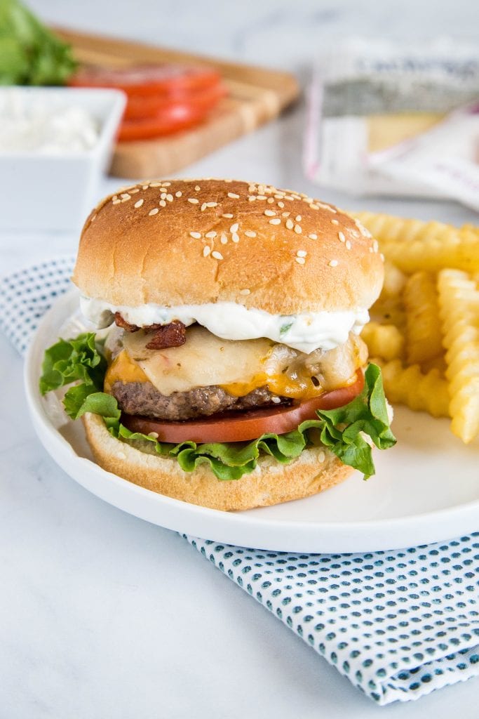 Spicy bacon cheeseburger plated with sauce