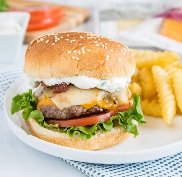 Spicy Bacon Cheeseburger - get ready for summer with easy homemade hamburgers topped with bacon, cheese, and a spicy ranch sauce!  