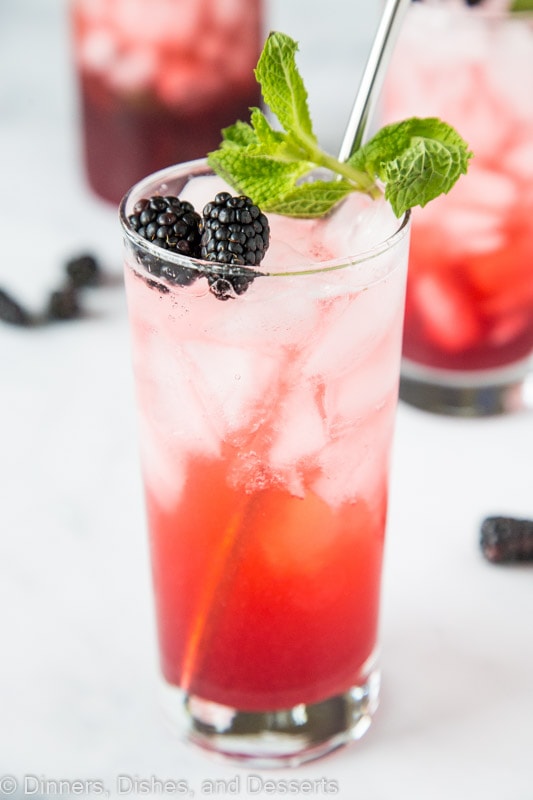 Blackberry Lime Punch front and center topped with mint and fresh berries