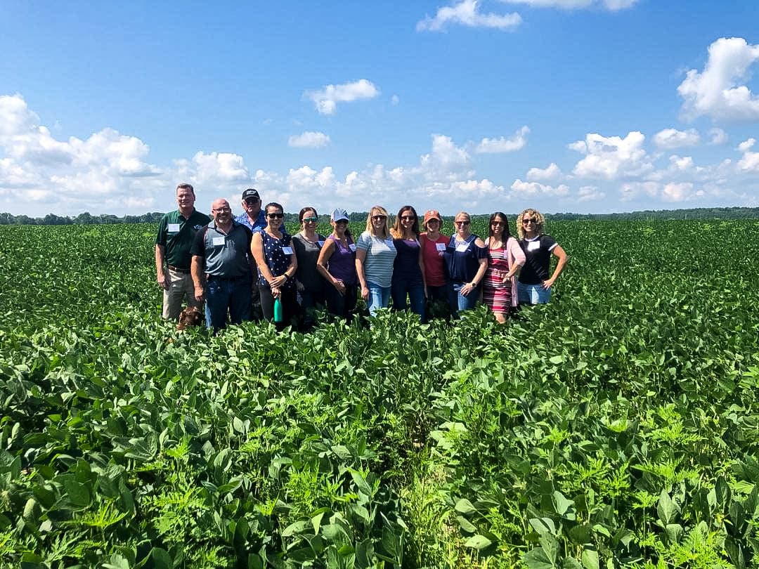 In the field learning all about how soy beans are grown and sustainable farming.