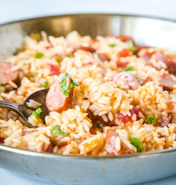 A bowl of food with rice and vegetables