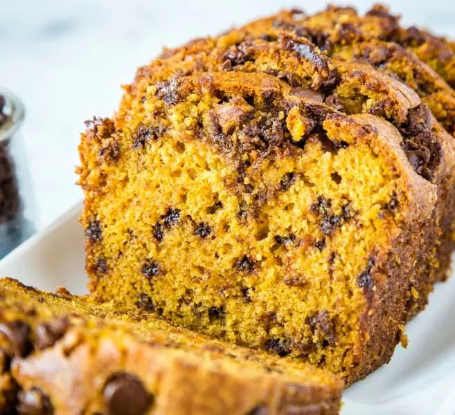 A close up of a piece of pumpkin bread on a plate