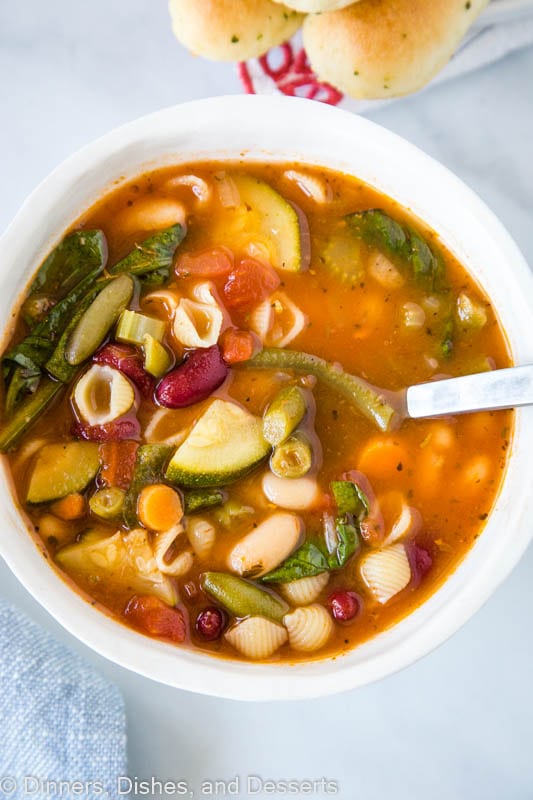 A bowl of hearty minestrone soup with shell pasta, and tons of veggies