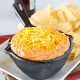 Easy Refried Bean Dip - this easy bean dip is super creamy, cheesy, and full of taco flavors.  This is always a hit at parties, and great for taco night. 