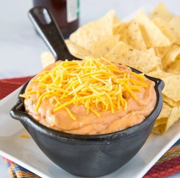 Easy Refried Bean Dip - this easy bean dip is super creamy, cheesy, and full of taco flavors.  This is always a hit at parties, and great for taco night. 