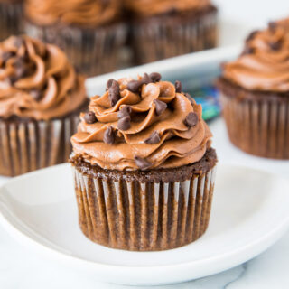 A large chocolate cupcake on a plate