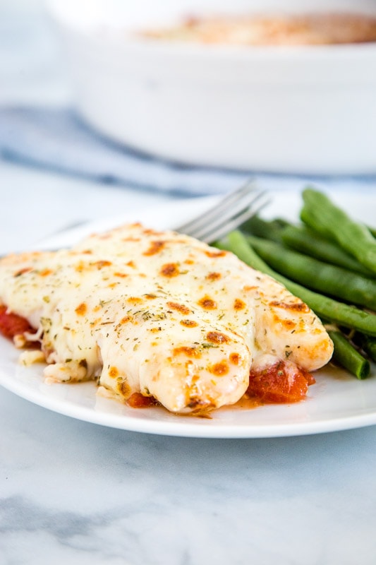 Garlic Tomato Baked Chicken plated with green beans