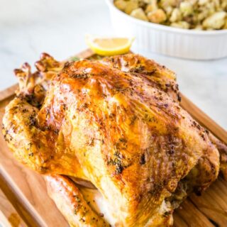A close up of a plate with a whole roasted turkey with Dinner