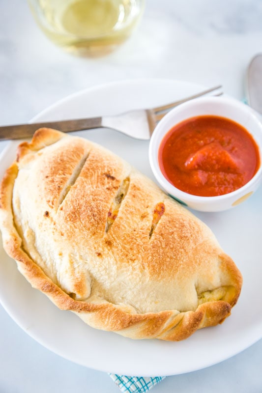 Sausage Calzones with pizza sauce on the side for dipping