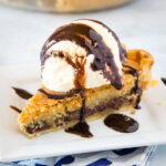 A piece of pie and ice cream on a plate, with Chocolate and Cookie
