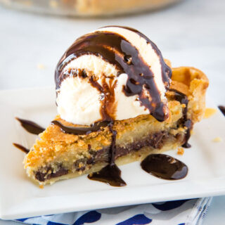A piece of pie and ice cream on a plate, with Chocolate and Cookie